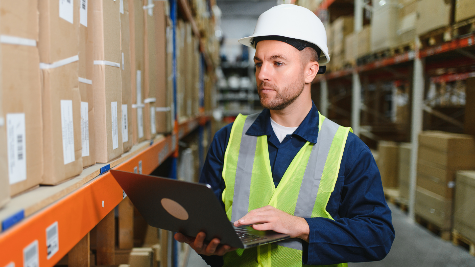 Man in warehouse holding ipad